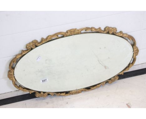 Oval Bevelled Edge Mirror with a scrolling gilt frame, 67cm x 39cm 