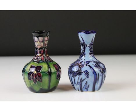 Two Moorcroft pottery vases of bulbous form to include a Violets pattern example on blue ground, initialled SW to underside, 