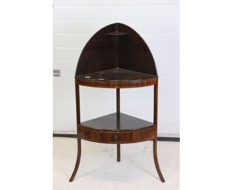 George III Corner Mahogany Washstand, washbowl aperture filled, the lower shelf with drawer, 62cm wide x 117cm high 