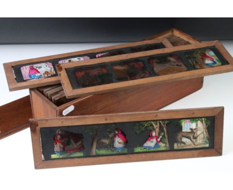 Collection of 11 Victorian multi-image coloured magic lantern story slides to include Little Red Riding Hood, housed within a