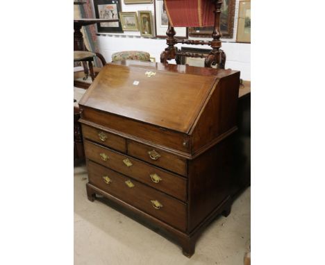 George III Mahogany Bureau, the fall front opening to a well fitted interior of pigeon holes, drawers and a well, the lower s