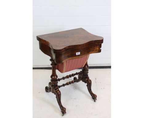 Victorian Burr Walnut Games and Sewing Table, the hinged fold-over swivel top opening to an inlaid chess, cribbage and backga