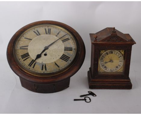 An early  20th century round faced wall clock of soft wood frame, 12-inch painted dial with Roman numerals with with key, dim