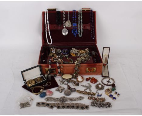 A collection of costume jewellery  in a leather jewellery box to include a selection of  brooches, earrings, two rings one ma