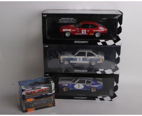 A collection of five racing model cars varying in scale and manufacturer. To include a 1:18 scale MiniChamps Ford Escort RS 1