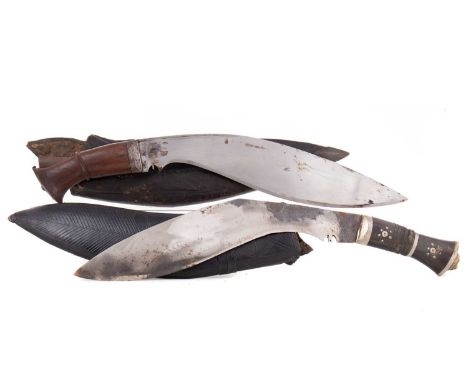 TWO NEPALESE KUKRI EARLY-MID 20TH CENTURY both in a leather clad scabbardKukri with plain handle has a blade size of 32cm. Th