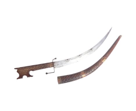 An early 20th Century North African Algerian / Moroccan Nimcha sword. Carved wood handle with a distinct hooked pommel. Curve