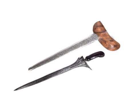 An early 20th Century Malayan Kris / Keris dagger. Carved wooden hilt, blade with pamor blade housed in an ornate pressed met