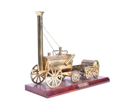 Railwayana - a vintage brass Railway interest model of Stephenson's Rocket. The model well detailed, and mounted on a wooden 