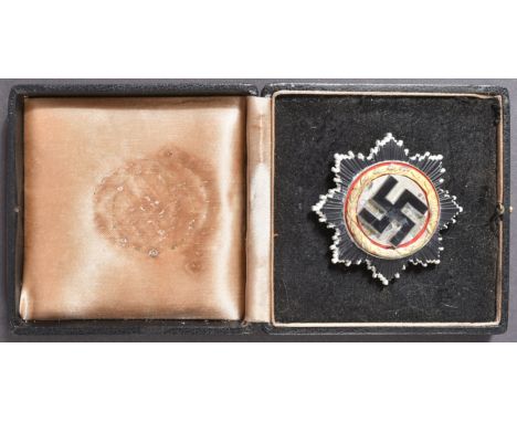 A replica WWII Second World War Third Reich Nazi German ' Deutsches Kruez ' ( The German Cross ) medal. The German Cross bein