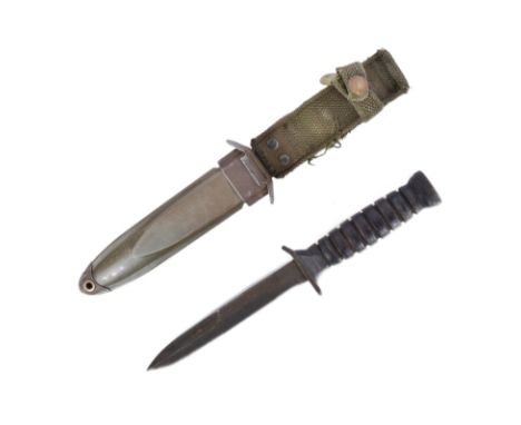 A WWII Second World War US United States Paratroopers M3 Fighting Knife. Flat pommel stamped with flaming grenade, grooved le