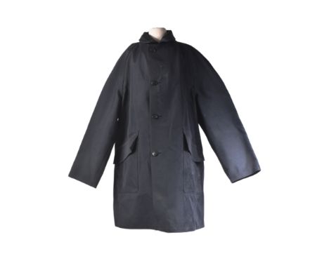 A vintage British Railways double texture waterproof Mackintosh coat with double arrow buttons. Makers label to inside lining