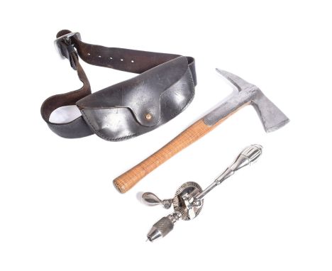 An original vintage Firemans axe with a polished steel head mounted onto a wooden shaft along with leather belt along with a 