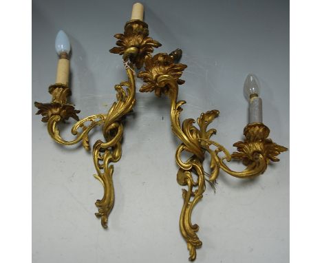 A pair of Rococo style gilt metal twin sconce wall light fittings
