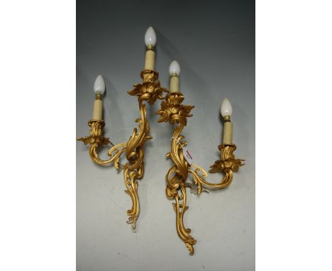 A pair of Rococo style gilt metal twin sconce wall light fittings