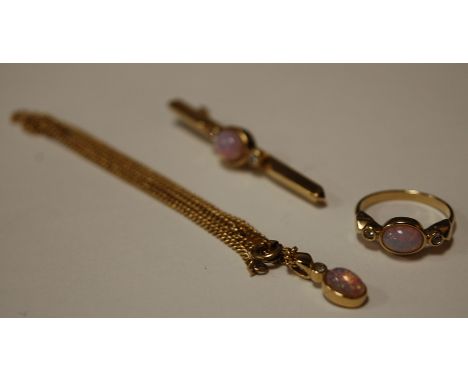 A gilt metal opal and paste set three piece garniture comprising; ring, bar brooch and pendant on chain 
