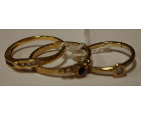 A ladies 9ct gold diamond solitaire ring; one other yellow gold garnet and diamond set ring; and an amethyst solitaire ring (