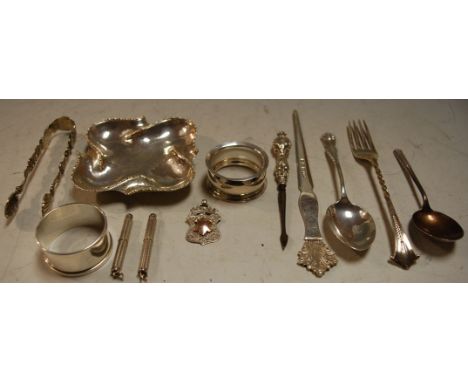 A small collection of silver and continental white metal items to include two silver engine turned cigar piercers, silver and