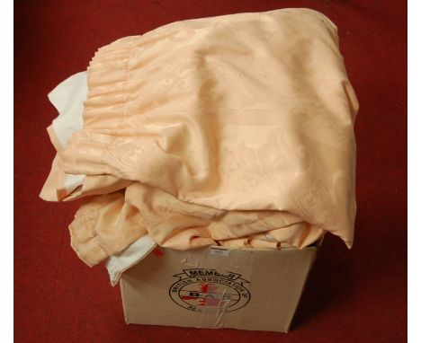 A box of assorted lined salmon pink curtains