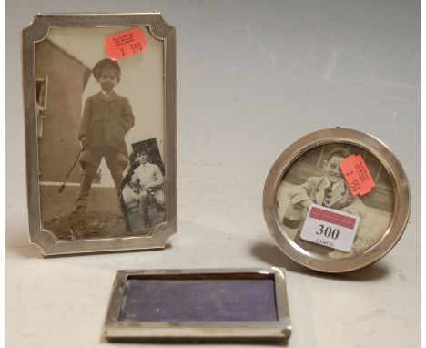 An Art Deco silver easel photograph frame with engine turned decoration together with two other silver photograph frames (3) 