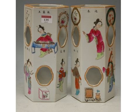 A pair of circa 1900 Chinese hexagonal vases, each decorated in the famille rose palette with figures and objects, seal mark 