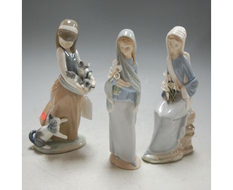 A Lladro figure of a girl with kittens; together with two Lladro flower-girls (3)