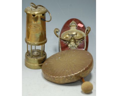 A Victorian brass wall hanging dinner gong; together with a brass miners safety lamp; and a brass magazine rack (3)