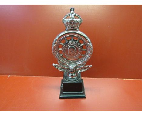 A chromed reproduction "The Royal Automobile Club" badge with enamelled centre mounted on a plinth, 22cm tall