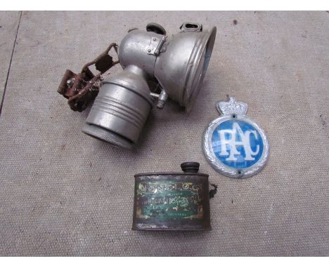 A "Nonclog, Lubricatng Oil" tin, a plastic RAC badge and a bicycle lamp a/f