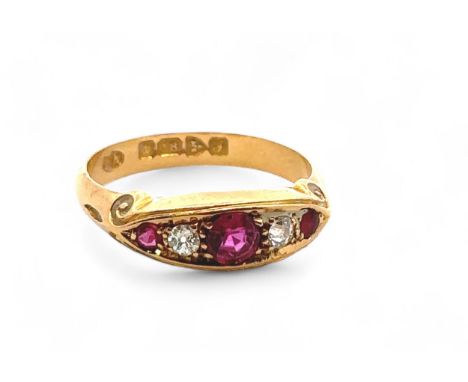An 18ct yellow gold ruby and diamond gypsy ring, size L/M. 1909 Chester hallmarks. Small chip to girdle of one of the diamond