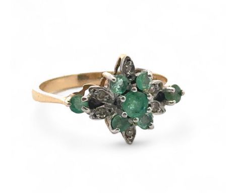 An emerald and diamond cluster ring, size O, stamped 14ct. Weight 2.53g.