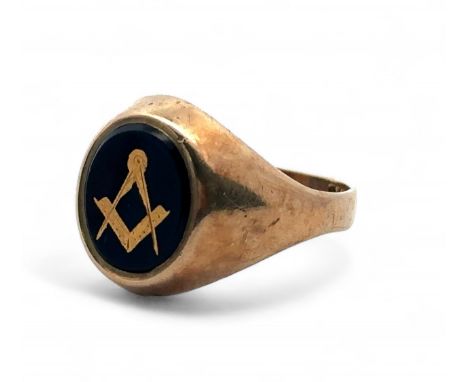 A 9ct gold signet ring with black oval onyx decorated with gilt Masonic square and compass. Size . Weight 4.4g.  Sponsor V.G 