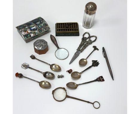 A range of silver and white metal items. Includes six hallmarked decorative teaspoons, a silver pen, a magnifying glass with 