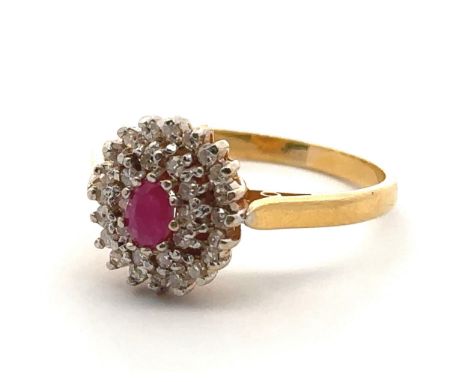A 22ct gold, ruby and diamond cluster ring. Central oval ruby approx 45mmx 3mm surrounded by a double border of diamonds. Spo