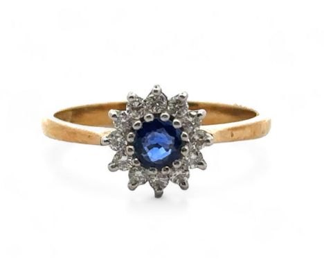 An 18ct gold, sapphire and diamond cluster ring, size N. Sapphire approx 4mm in diameter -likely synthetic. Total diamond wei