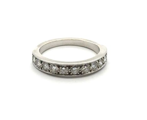 An eleven stone diamond half eternity ring, size M. Unmarked white metal tested as platinum using XRF. Estimated total diamon
