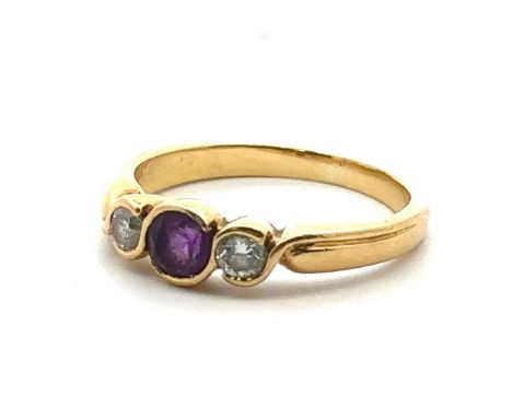 An 18ct gold, amethyst and diamond three stone ring, size M. Total diamond weight approx 0.14ct. Weight 3.73g.