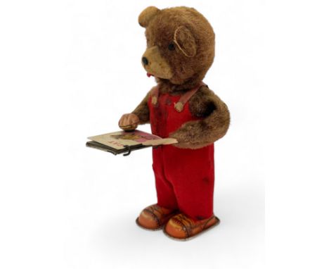 An original vintage 1960's tinplate clockwork  - 'Cubby - The Reading Bear ' automoton, Comprising of a faux fur covered tinp