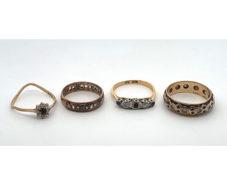 Four gold and gem set rings. A white stone ring hallmarked 9ct, a sapphire and diamond ring stamped 18ct and plat, a white cz