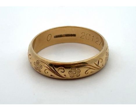 An 18ct yellow gold ring with engraved foliate decoration, size O Size Hallmarks for CG &amp; S, Birmingham 1987. 
