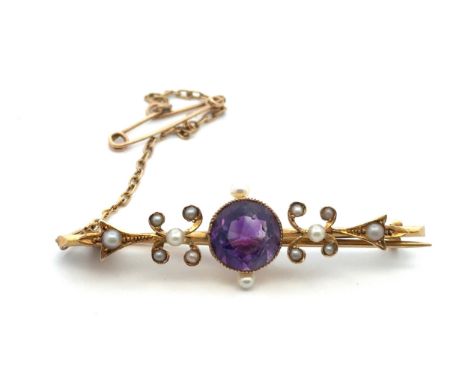 An art nouveau amethyst and seed pearl  brooch stamped 15ct. Length of brooch 46mm. Amethyst with typical inclusion, small ni