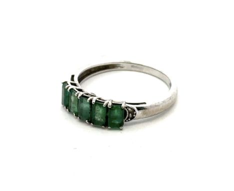 A five stone emerald ring set in 9ct white gold with accent diamond shoulders. Size S. 