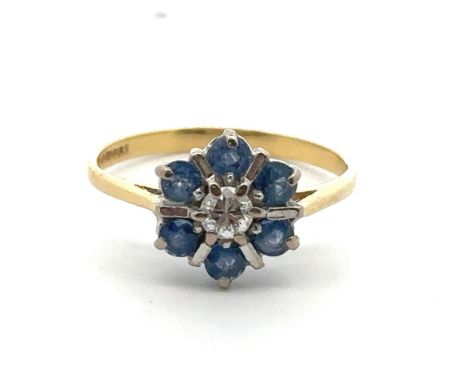 A modern 18ct sapphire and diamond flower ring, size L. Central diamond approx 0.17ct. Hallmarks for GJ, Birmingham 1989. Wei