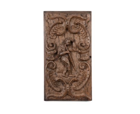 A carved oak panel, Dutch,17th centuryDepicting a man with a walking stick or staff, 37cm x 20cm.