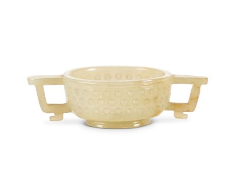 A small Chinese Ming Dynasty carved pale jade twin-handled libation cup9cm wide.