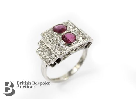 Art Deco platinum diamond and ruby ring. The stepped ring set with two pigeon-blood rubies approx 4.6mm each, approx 35pts of