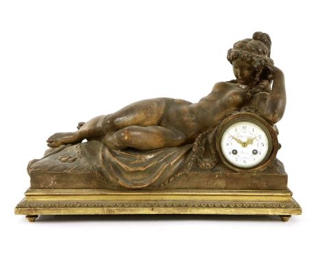 A large Louis XVI-style terracotta mantel clock, 19th century, in the form of a reclining nude female with hair tied back, th