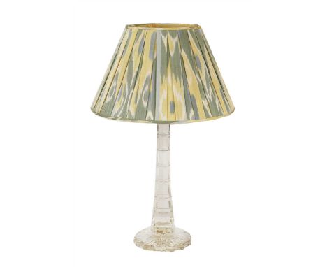 A large faceted glass table lamp, 20th century, the tapering column on a petal form base, with a pleated mottled shade, 89cm 