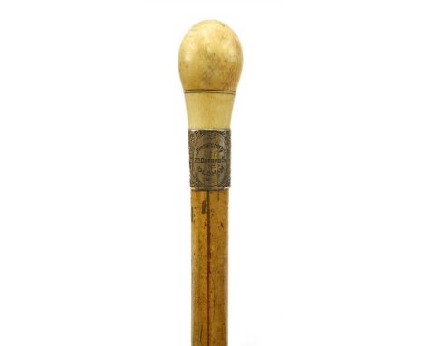 An ivory and malacca gadget cane , late 19th century, the ivory knob unscrewing to reveal a corkscrew, with an engraved silve