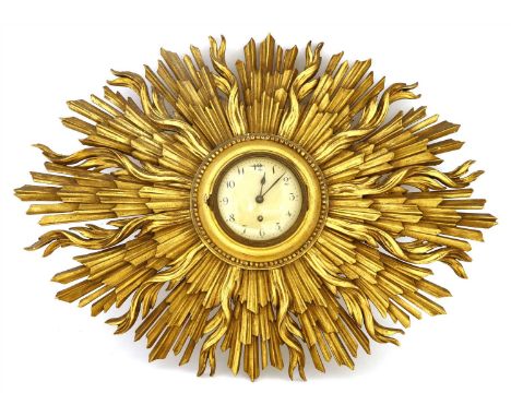 A carved and gilt sunburst wall clock, 20th century, centred with a painted Arabic dial, 60cm wide 45cm high Provenance: Sir 
